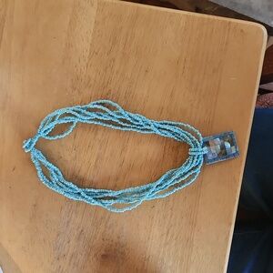 Beautiful light blue beaded Necklace with mother of pearl/blue coral pendant